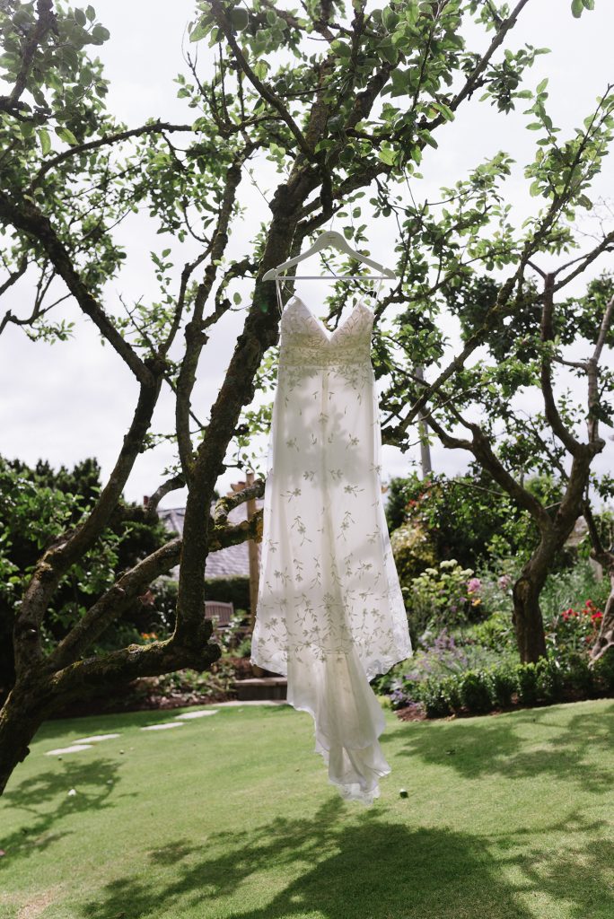 wedding dress hanging up in tree