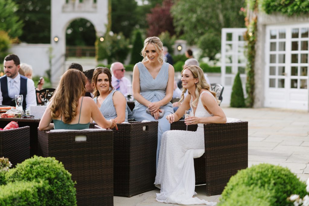 bride and friends casually chatting at Castle Bellingham, Louth, Ireland